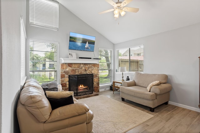 5403 Carousel Cir, Baytown, TX 77521 - living area featuring a fireplace, light wood-type flooring, baseboards, ceiling fan, and high vaulted ceiling