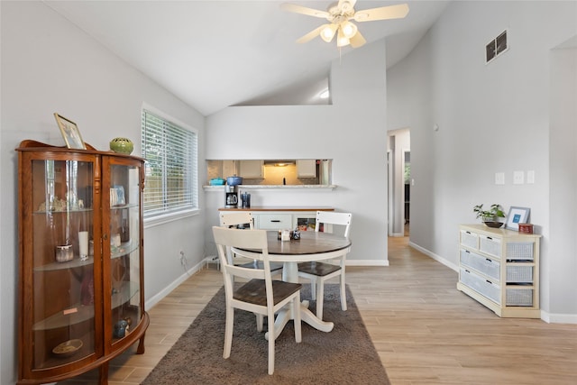 5403 Carousel Cir, Baytown, TX 77521 - dining area featuring baseboards, a ceiling fan, light wood finished floors, and high vaulted ceiling