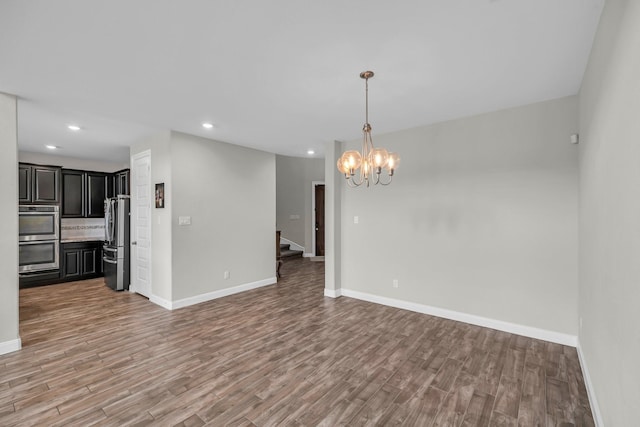 5803 Platinum Lakes Ct, Rosenberg, TX 77469 - unfurnished living room with light wood-type flooring, stairway, recessed lighting, a chandelier, and baseboards