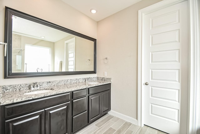5803 Platinum Lakes Ct, Rosenberg, TX 77469 - full bath with baseboards, double vanity, and wood tiled floors