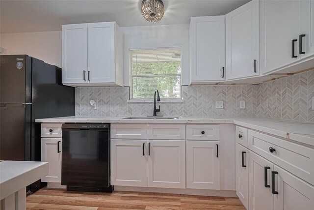 1029 Dolly Wright St, Houston, TX 77088 - kitchen featuring dishwasher, a sink, white cabinetry, and light wood-type flooring