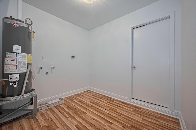 1029 Dolly Wright St, Houston, TX 77088 - laundry room with water heater, light wood-style floors, baseboards, washer hookup, and hookup for an electric dryer