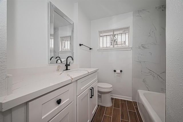 1029 Dolly Wright St, Houston, TX 77088 - bathroom featuring vanity, toilet, wood tiled floors, and baseboards