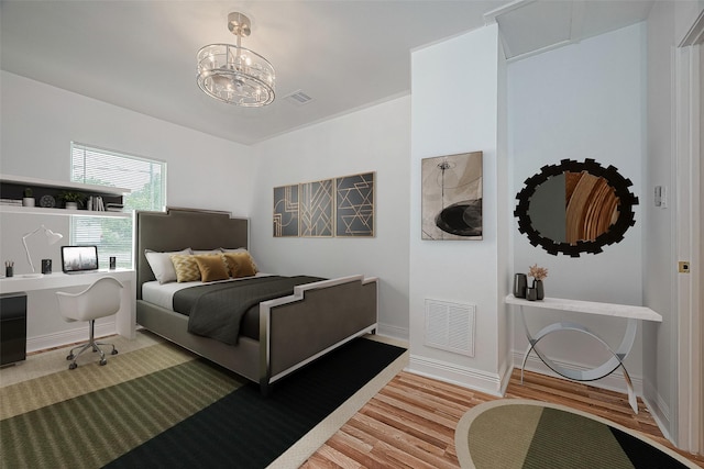 1029 Dolly Wright St, Houston, TX 77088 - bedroom featuring light wood-style floors, baseboards, and a chandelier