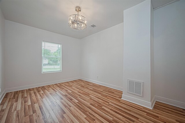 1029 Dolly Wright St, Houston, TX 77088 - spare room with a chandelier, light wood-type flooring, and baseboards