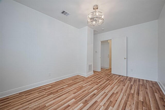 1029 Dolly Wright St, Houston, TX 77088 - spare room featuring light wood-style flooring, baseboards, and a chandelier