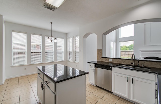 6018 Lamb Crk, Missouri City, TX 77459 - kitchen with dishwasher, a sink, light tile patterned floors, white cabinets, and a kitchen island