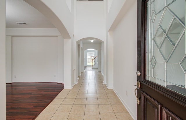 6018 Lamb Crk, Missouri City, TX 77459 - foyer entrance with arched walkways, light tile patterned floors, and baseboards