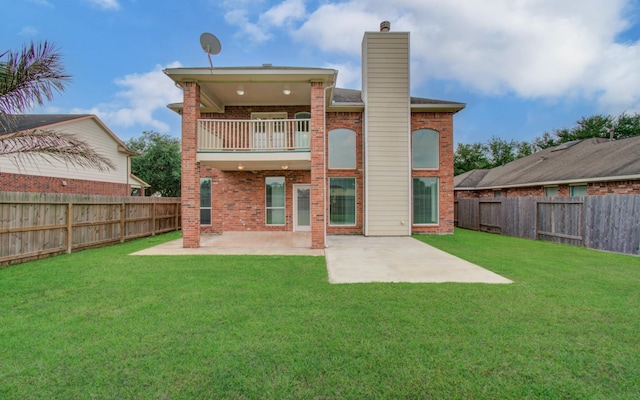 6018 Lamb Crk, Missouri City, TX 77459 - back of house with a balcony, brick siding, a chimney, and a patio