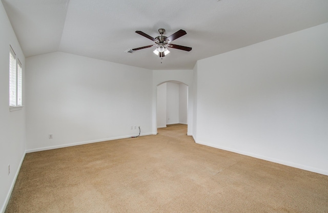 6018 Lamb Crk, Missouri City, TX 77459 - spare room featuring light colored carpet, arched walkways, ceiling fan, baseboards, and lofted ceiling