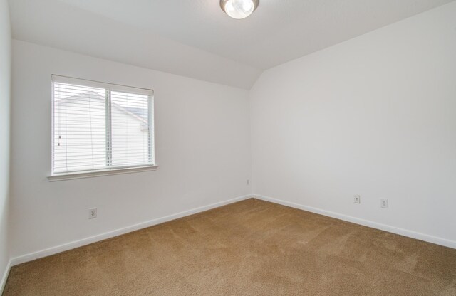 6018 Lamb Crk, Missouri City, TX 77459 - empty room featuring light carpet, lofted ceiling, and baseboards