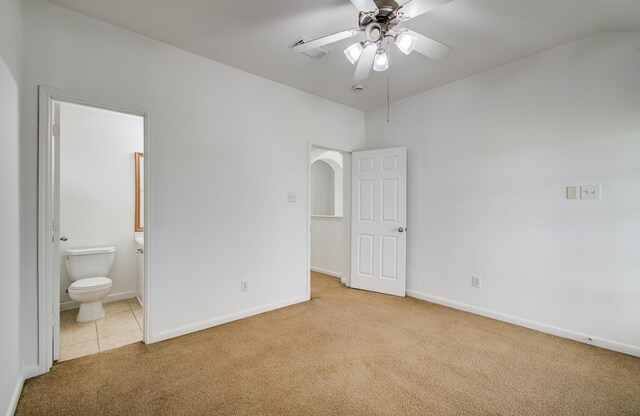 6018 Lamb Crk, Missouri City, TX 77459 - unfurnished bedroom featuring carpet flooring, baseboards, connected bathroom, tile patterned flooring, and arched walkways