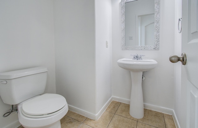 6018 Lamb Crk, Missouri City, TX 77459 - bathroom featuring tile patterned flooring, toilet, baseboards, and a sink
