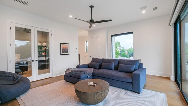 1410 Indiana St, Houston, TX 77006 - living room with french doors, wood finished floors, ceiling fan, recessed lighting, and baseboards