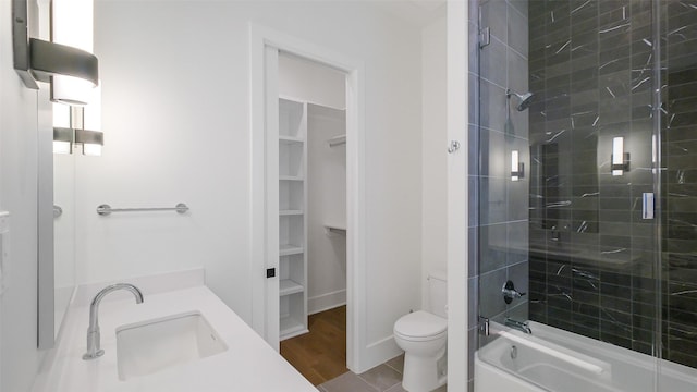 1410 Indiana St, Houston, TX 77006 - bathroom featuring toilet, a sink, a walk in closet, and combined bath / shower with glass door