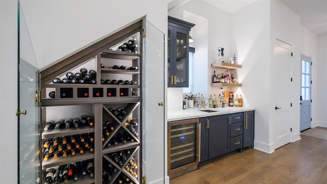 1410 Indiana St, Houston, TX 77006 - wine area with wine cooler, bar with sink, wood finished floors, and baseboards