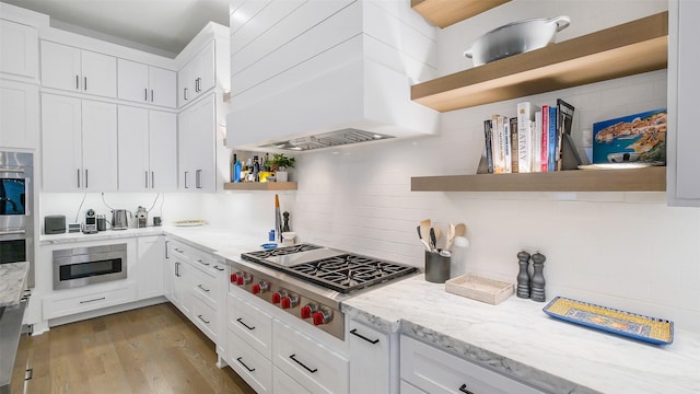 1410 Indiana St, Houston, TX 77006 - kitchen with open shelves, stainless steel appliances, white cabinets, premium range hood, and decorative backsplash