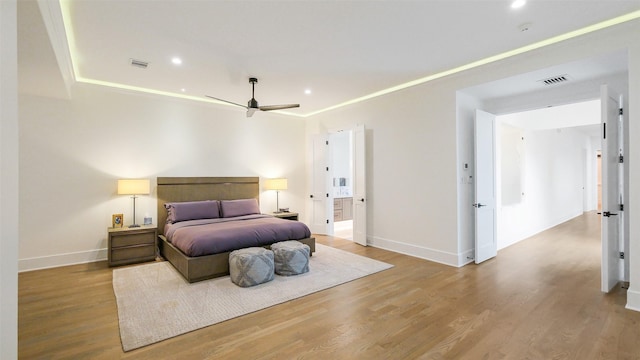 1410 Indiana St, Houston, TX 77006 - bedroom with wood finished floors, baseboards, recessed lighting, ensuite bath, and a ceiling fan
