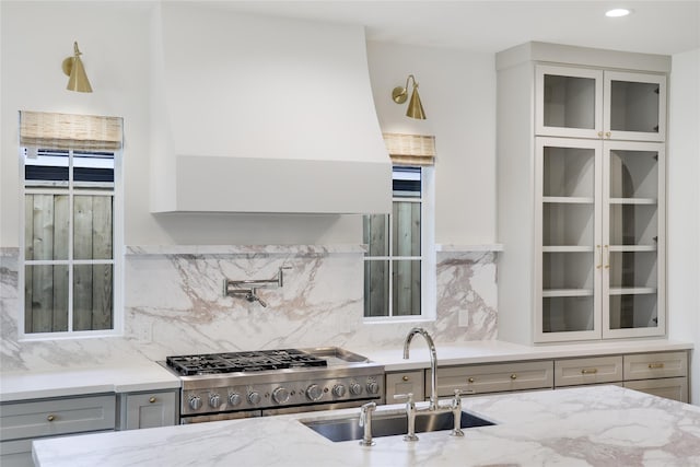 1732 Libbey Dr, Houston, TX 77018 - kitchen with gray cabinetry, a sink, light stone counters, and custom exhaust hood