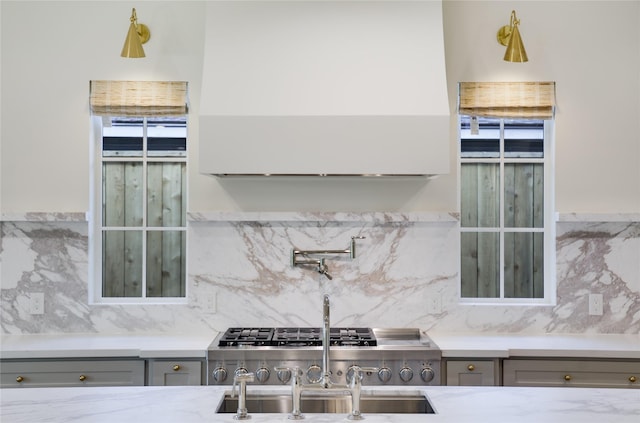 1732 Libbey Dr, Houston, TX 77018 - kitchen with gray cabinetry, backsplash, and light stone countertops