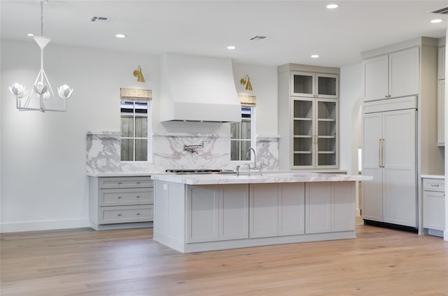 1732 Libbey Dr, Houston, TX 77018 - kitchen featuring premium range hood, gray cabinetry, a sink, paneled fridge, and light wood finished floors