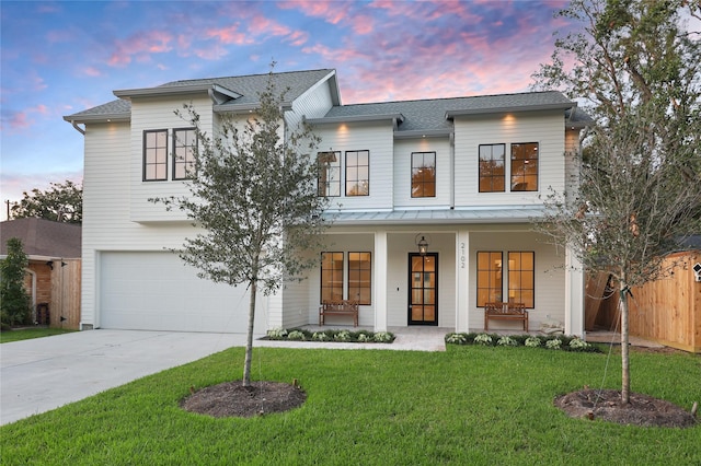 1732 Libbey Dr, Houston, TX 77018 - modern farmhouse featuring a standing seam roof, a garage, covered porch, driveway, and roof with shingles