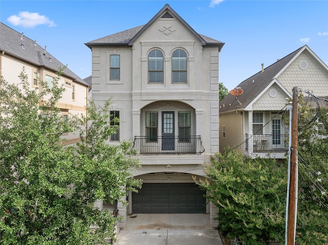 1415 W 21st St Unit A, Houston, TX 77008 - view of front of property featuring a balcony, a garage, stucco siding, and concrete driveway