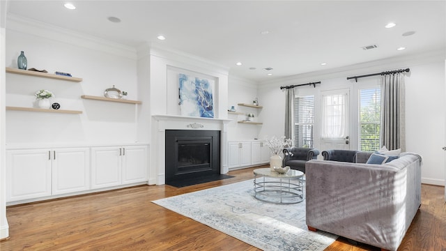 1415 W 21st St Unit A, Houston, TX 77008 - living room with ornamental molding, light wood finished floors, a fireplace with flush hearth, and recessed lighting
