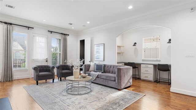 1415 W 21st St Unit A, Houston, TX 77008 - living area featuring crown molding, arched walkways, light wood-style floors, baseboards, and recessed lighting