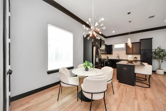 1544 W 23rd St Unit B, Houston, TX 77008 - dining space featuring ornamental molding, light wood-type flooring, a chandelier, and baseboards