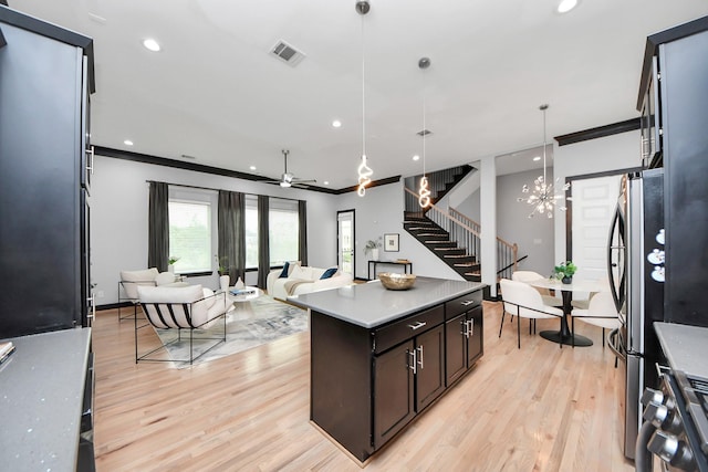 1544 W 23rd St Unit B, Houston, TX 77008 - kitchen with open floor plan, light wood-type flooring, a center island, hanging light fixtures, and ornamental molding