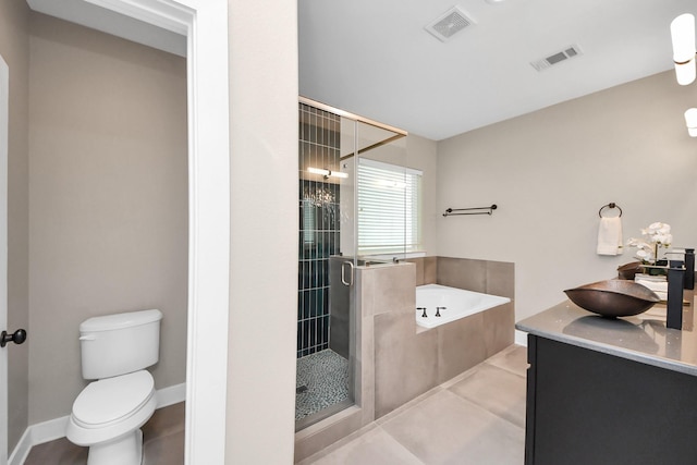 1544 W 23rd St Unit B, Houston, TX 77008 - bathroom featuring a bath, a shower stall, toilet, and double vanity