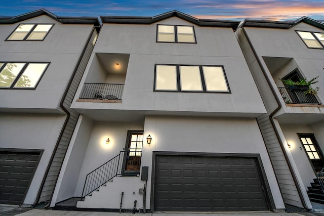 1544 W 23rd St Unit B, Houston, TX 77008 - townhome / multi-family property with stucco siding, an attached garage, a balcony, and stairway