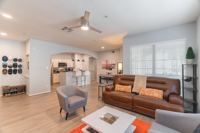 6607 Lake Woodlands Dr Unit 312, The Woodlands, TX 77382 - living area featuring arched walkways, light wood-type flooring, ceiling fan, baseboards, and recessed lighting