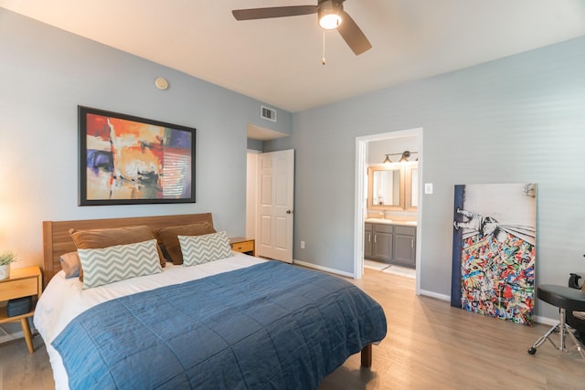 6607 Lake Woodlands Dr Unit 312, The Woodlands, TX 77382 - bedroom featuring light wood-style floors, baseboards, connected bathroom, and a ceiling fan