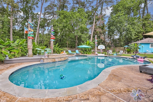 1310 Hickory Ln, Houston, TX 77339 - view of swimming pool featuring view of wooded area and a patio