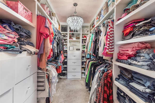 1310 Hickory Ln, Houston, TX 77339 - walk in closet with carpet flooring and a chandelier