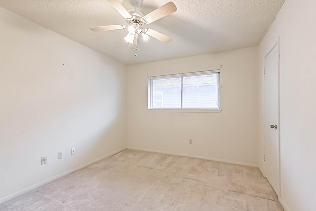 15419 Diana Ln, Houston, TX 77062 - unfurnished room featuring light carpet, a textured ceiling, ceiling fan, and baseboards