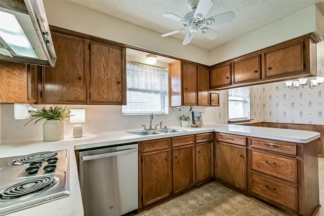 15419 Diana Ln, Houston, TX 77062 - kitchen with stainless steel appliances, a sink, a peninsula, light countertops, and a textured ceiling