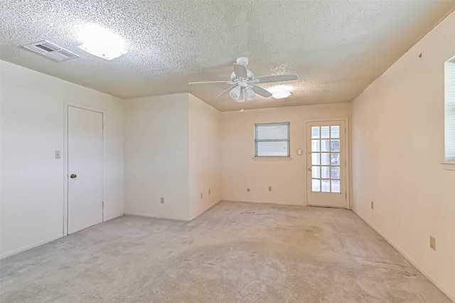 15419 Diana Ln, Houston, TX 77062 - unfurnished room with light carpet, ceiling fan, and a textured ceiling