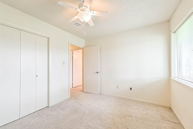 15419 Diana Ln, Houston, TX 77062 - unfurnished bedroom with light carpet, a textured ceiling, a closet, and ceiling fan