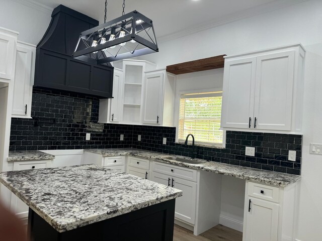 4120 Buffalo St, Beaumont, TX 77703 - kitchen featuring a sink, light stone countertops, backsplash, ornamental molding, and open shelves