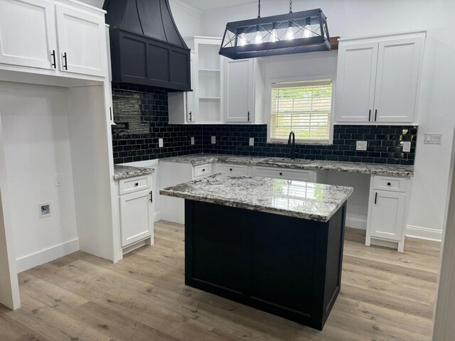 4120 Buffalo St, Beaumont, TX 77703 - kitchen featuring a sink, light stone counters, white cabinetry, and ornamental molding