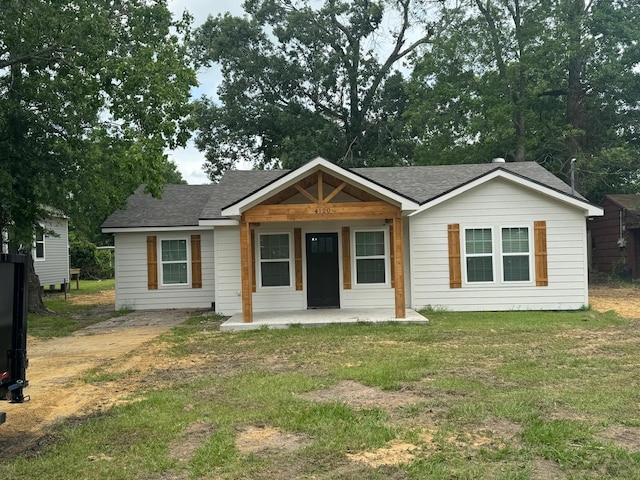 4120 Buffalo St, Beaumont, TX 77703 - view of front of house featuring a shingled roof and a front lawn