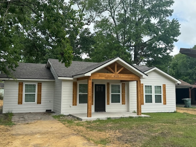 4120 Buffalo St, Beaumont, TX 77703 - ranch-style home with a shingled roof and a front yard