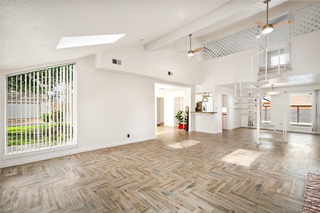 707 Center Hill Dr, Houston, TX 77079 - unfurnished living room with stairs, high vaulted ceiling, a ceiling fan, a skylight, and baseboards