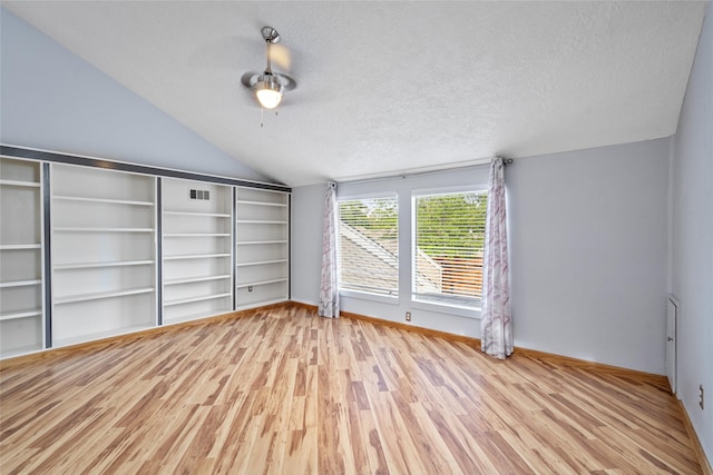 707 Center Hill Dr, Houston, TX 77079 - unfurnished living room featuring vaulted ceiling, wood finished floors, ceiling fan, and a textured ceiling