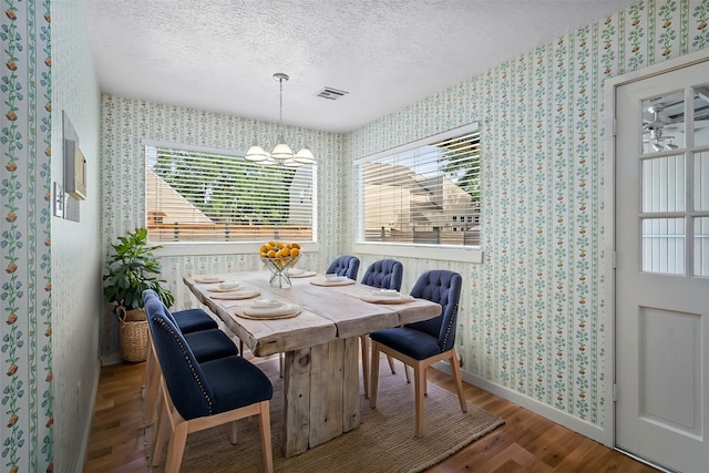 707 Center Hill Dr, Houston, TX 77079 - dining space with wallpapered walls, wood finished floors, a textured ceiling, baseboards, and plenty of natural light