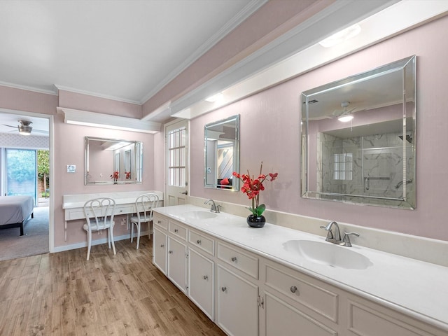 707 Center Hill Dr, Houston, TX 77079 - full bathroom with ceiling fan, ornamental molding, a stall shower, wood finished floors, and double vanity