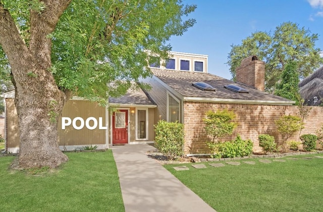 707 Center Hill Dr, Houston, TX 77079 - view of front of house with a front lawn, a chimney, brick siding, and roof with shingles